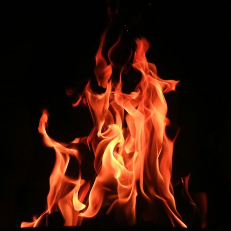 Flames dance in front of a black background